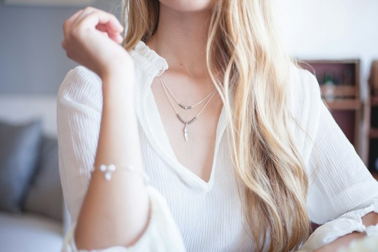 woman wearing white long-sleeved blouse