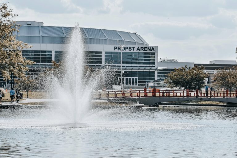 a water fountain in front of a large building
