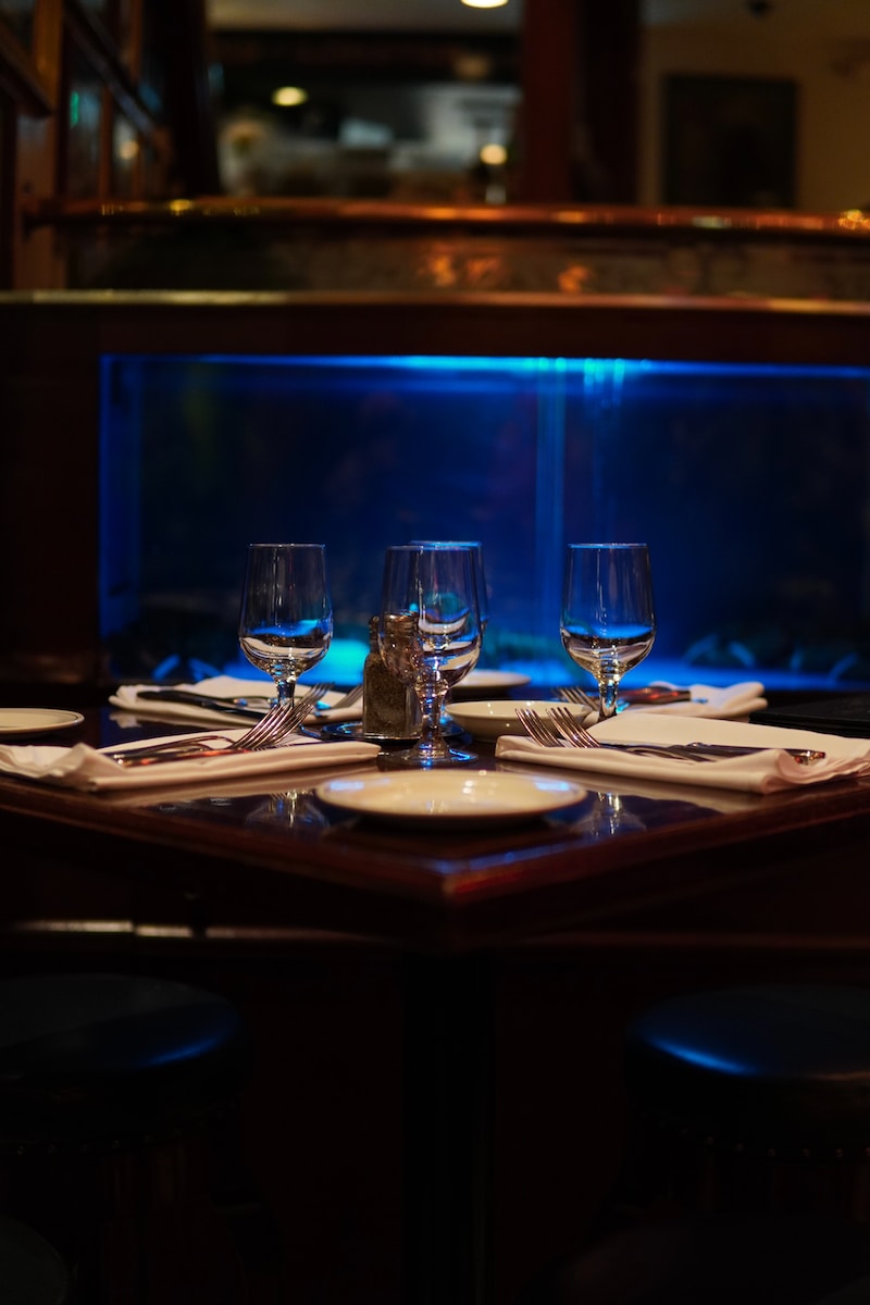 a table set with wine glasses and place settings